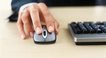 Mans hand on computer mouse